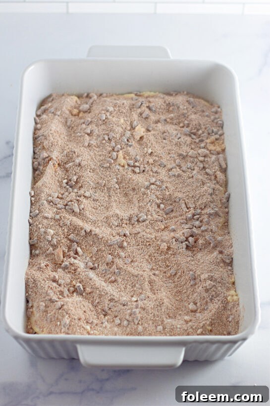 Adding the pecan topping to make the Honey Bun Cake recipe for the holidays