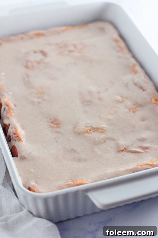 Photo of pouring the sweet glaze onto Honey Bun Cake recipe 