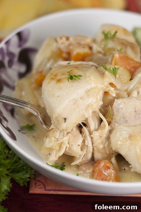 Creamy, comforting chicken and dumplings dinner recipe made in the crock pot that couldn't be easier to make. Just throw everything in your slow cooker and your supper is ready!