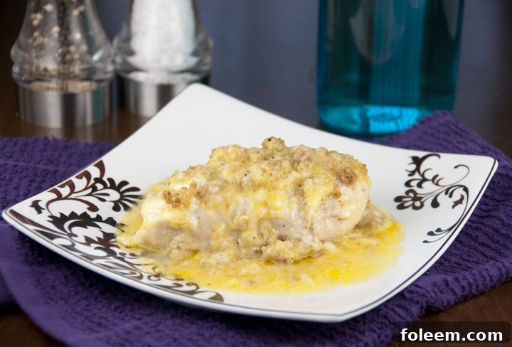 Close-up of baked Swiss Chicken with melted cheese and golden stuffing, in a casserole dish.