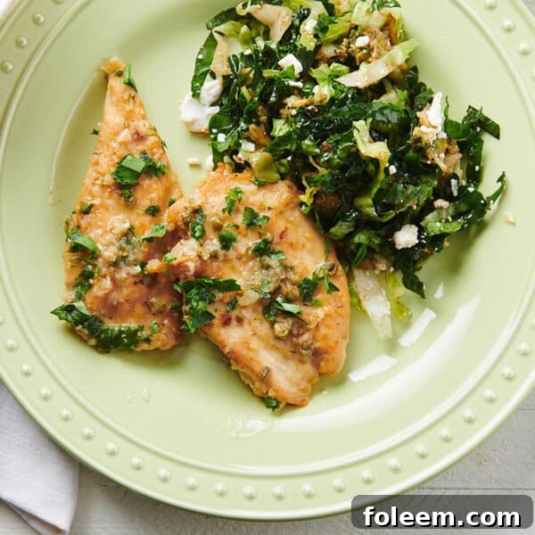 Chicken Piccata on a plate with greens.