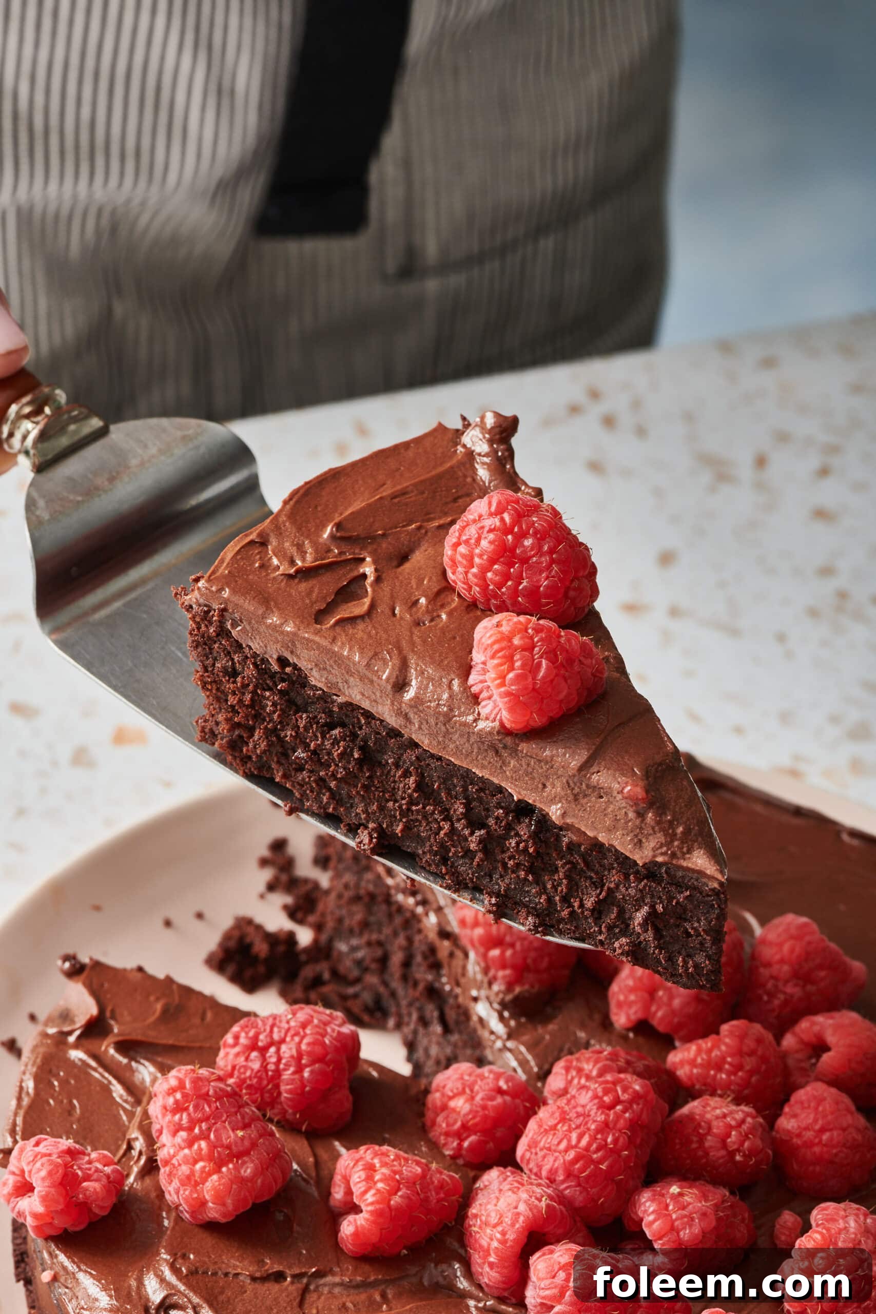 Moving perfectly sliced chocolate cake with spatula.