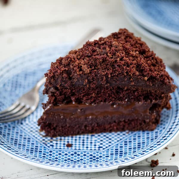 Slice of Ebinger’s Blackout Cake on a plate with a fork.