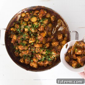 Indian Spiced Chicken and Potato Stew in a pot and in a bowl.