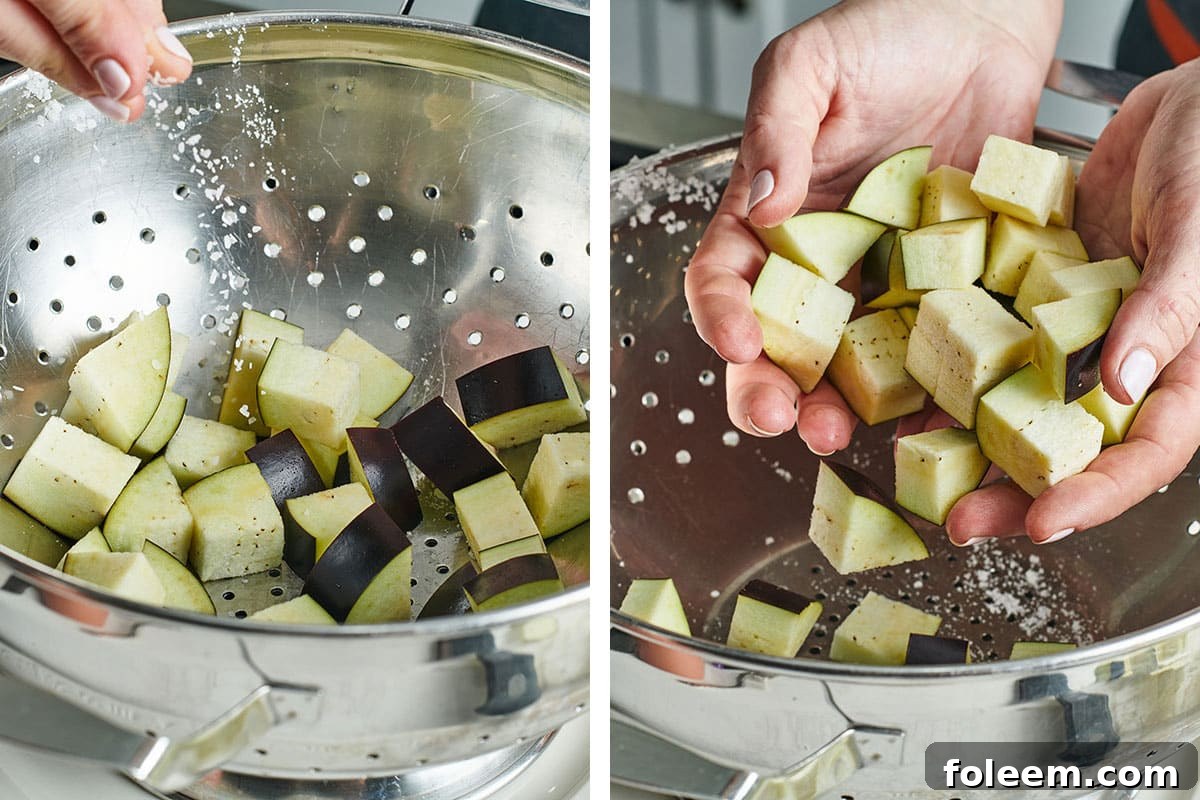 Katie Workman tossing cubed eggplant with salt.