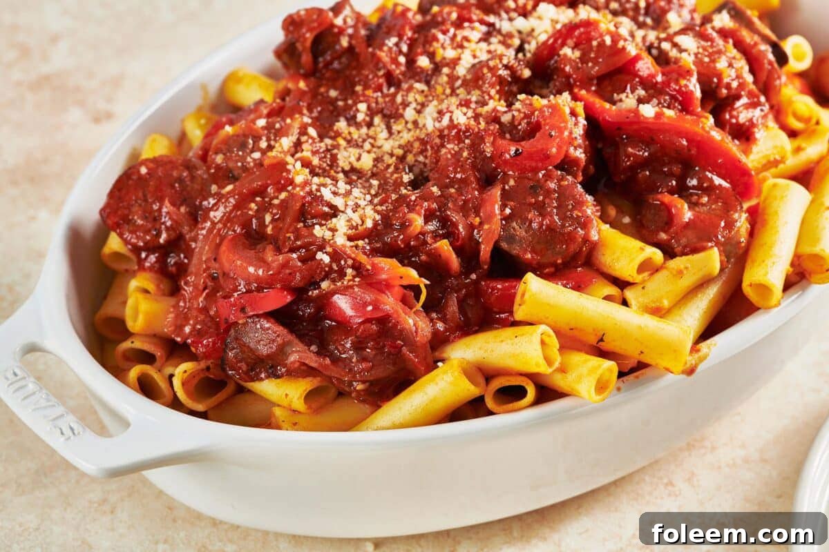 Sausage and Peppers Pasta in white serving dish.