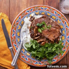 Pan-seared Pork Chops Marsala on colorful plate.