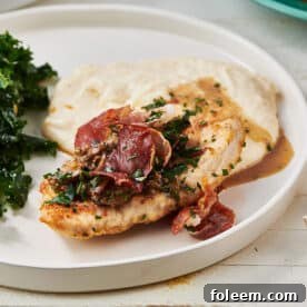 Turkey Marsala on a white plate with greens.