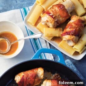 Chicken rolls wrapped in bacon on table with pasta and Marsala sauce.