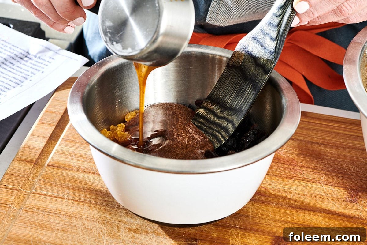 Pouring maple syrup into bowl for homemade granola.