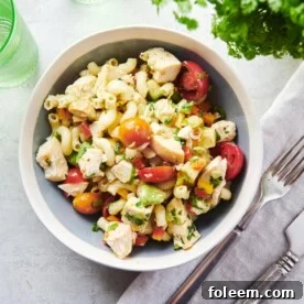 Table setting with a bowl of Pasta Salad with Chicken and a cloth napkin.