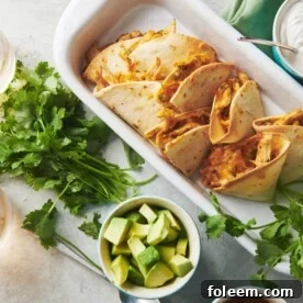 Baked chicken quesadillas in dish on table with toppings and drinks.