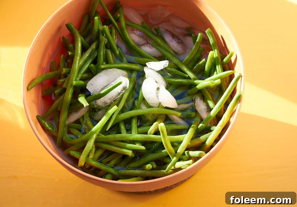 Blanched green beans in ice water bath.
