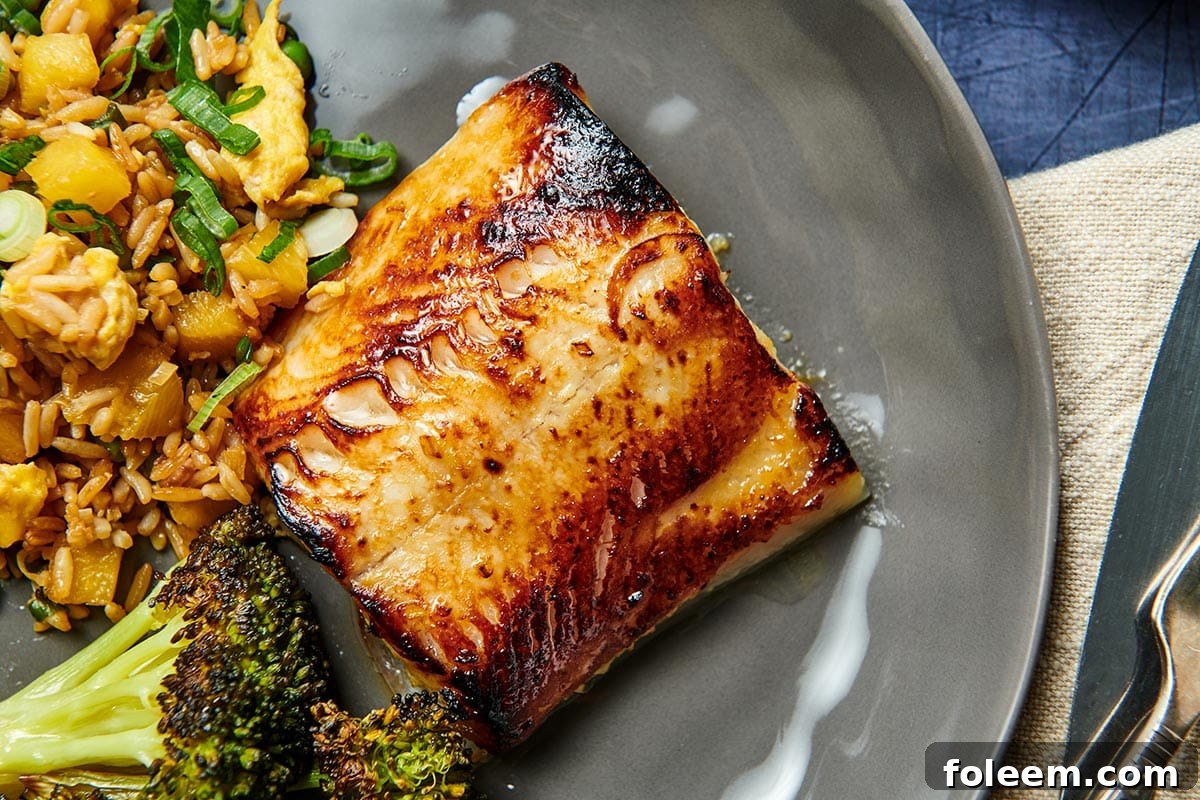 Miso black cod on grey plate.