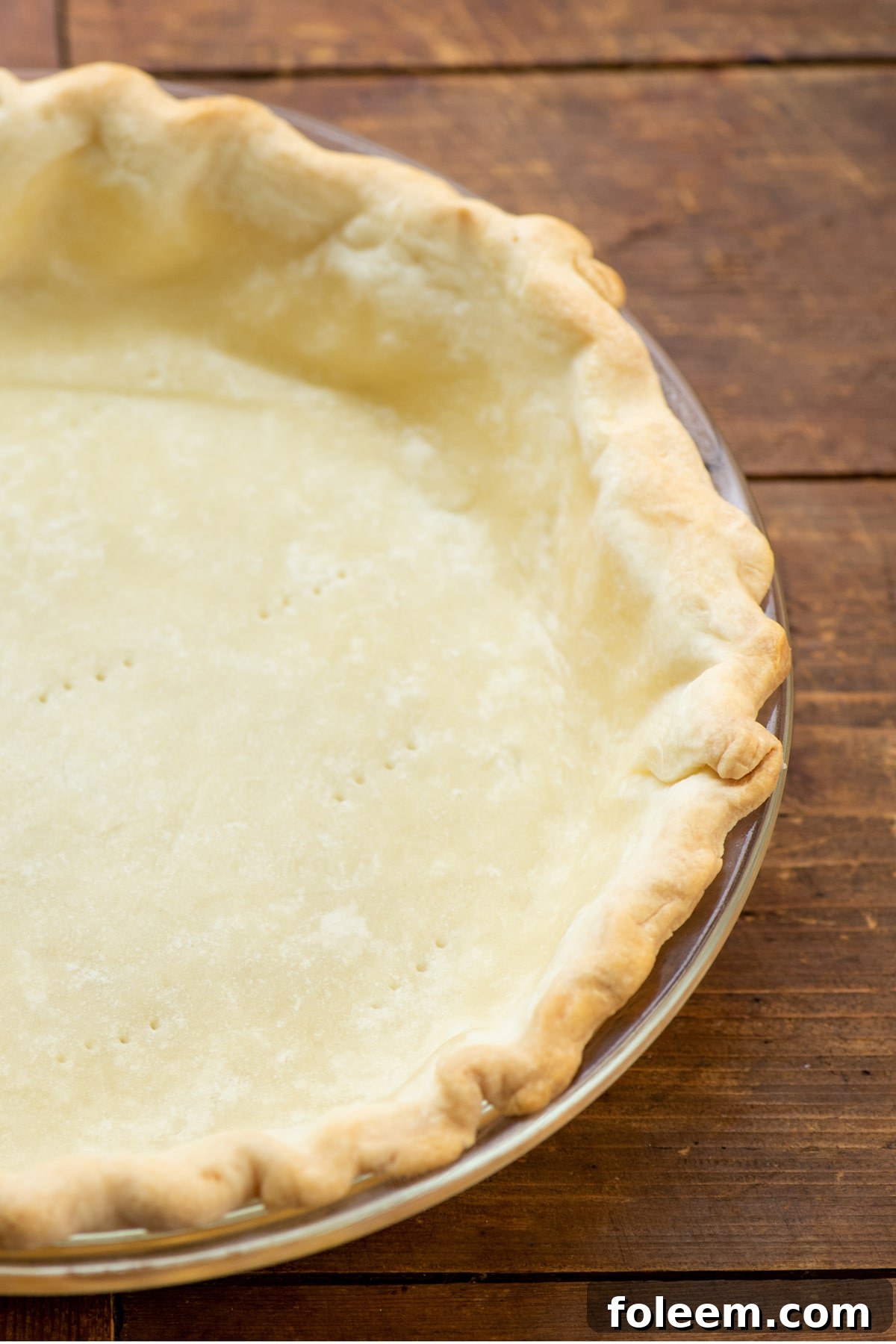 Cooked pit crust in a pie dish.