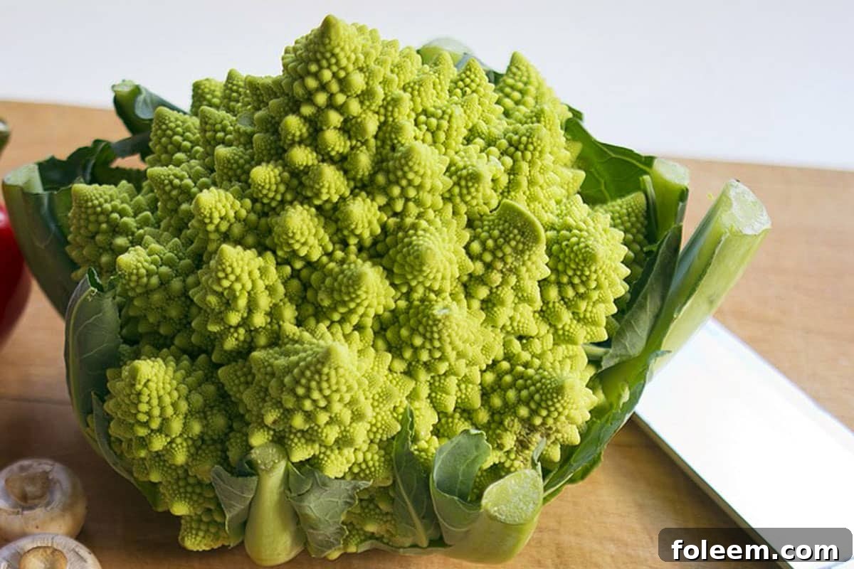 Head of Romanesco broccoli on cutting board with knife. - RonPorter / pixabay.com