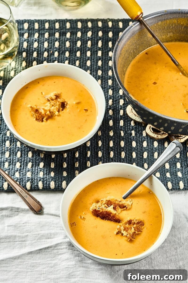 Two white bowls of Pumpkin Curry Soup.