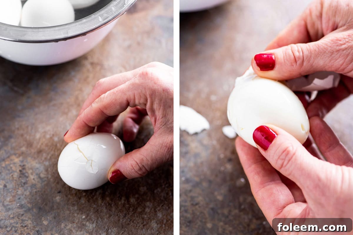 Woman peeling shell of hard boiled egg.