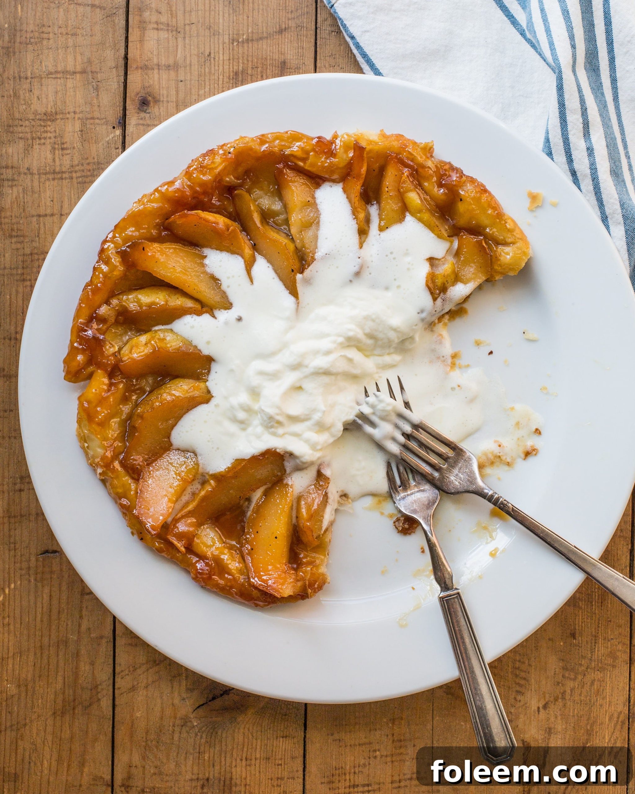 Pear Tartin Tatin with two forks on a plate.