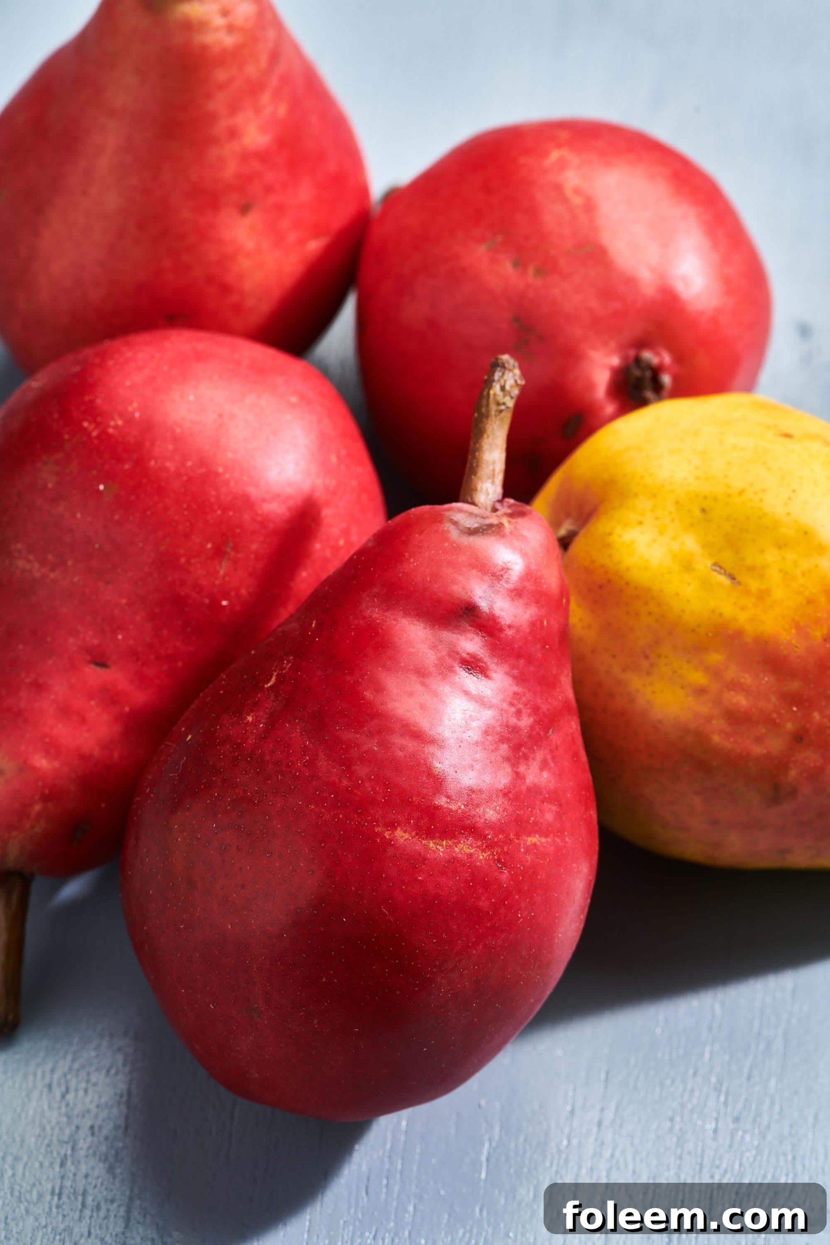 Multicolored pears on a surface.