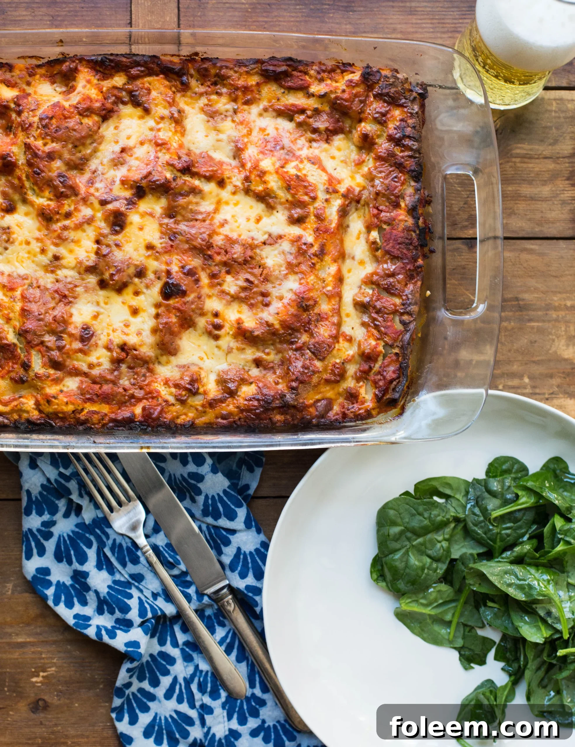 Beefy lasagna in a glass casserole pan.