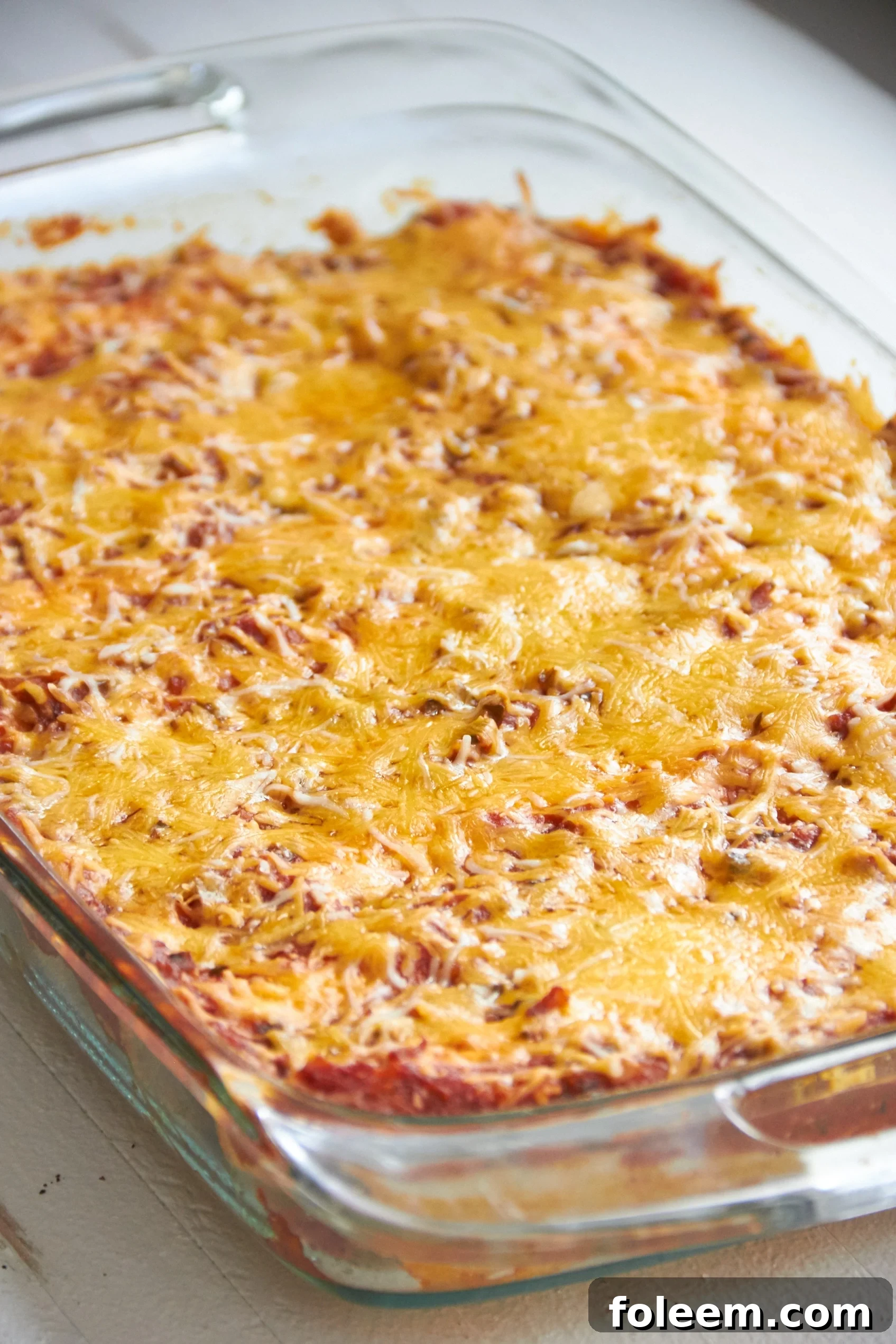 Spicy Chicken and Black Bean Enchiladas in a baking dish.