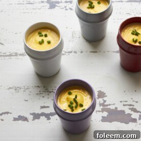 Small, differently colored cups of Butternut Squash and Fennel Soup.