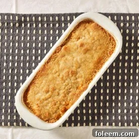 Butternut Squash Casserole in white dish on table.