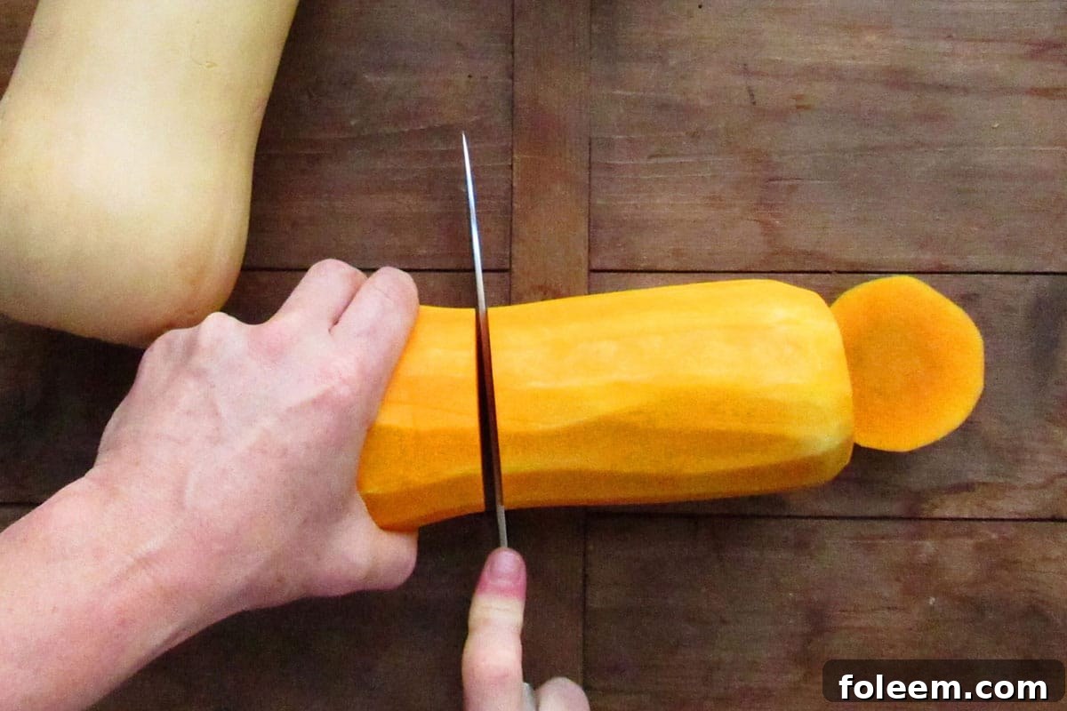 Slicing butternut squash in half.