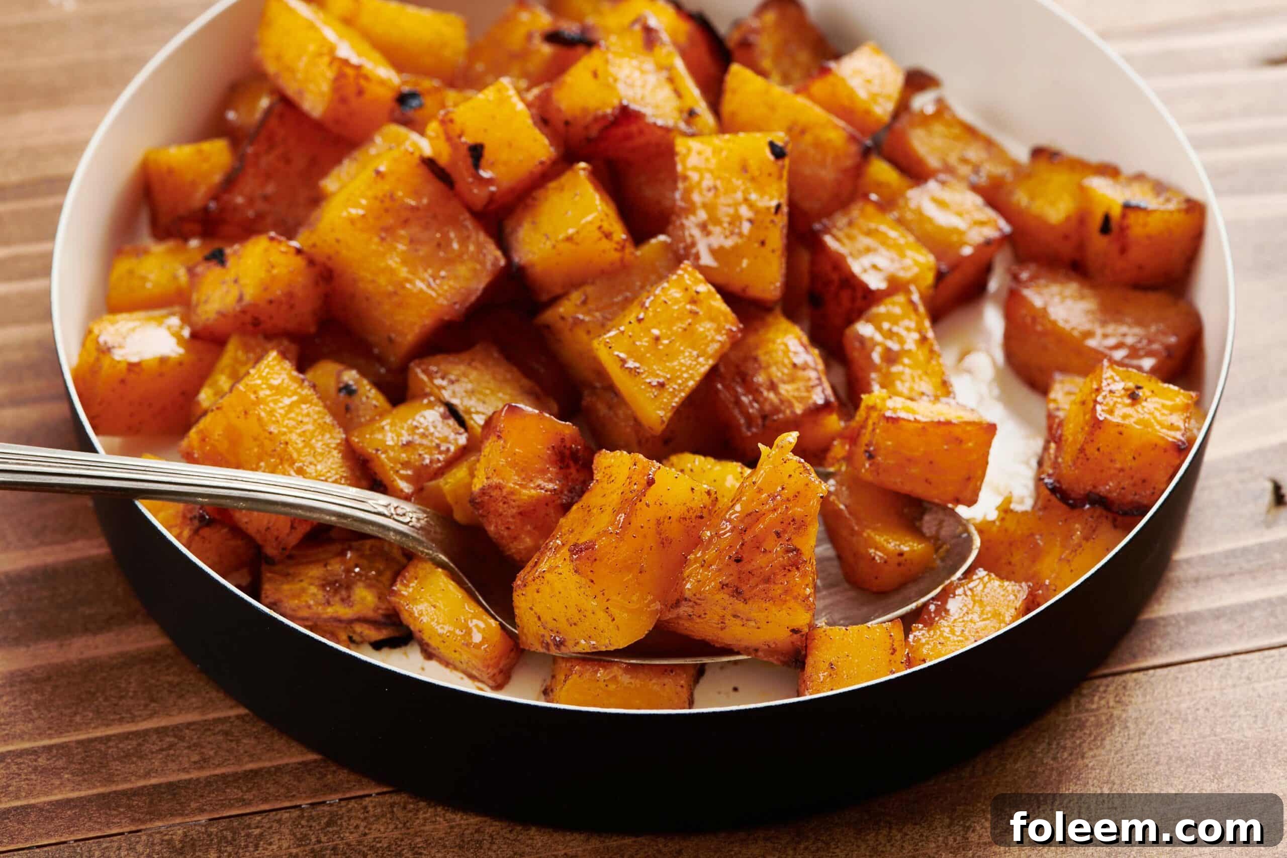 Maple Roasted Butternut Squash in serving dish with spoon.