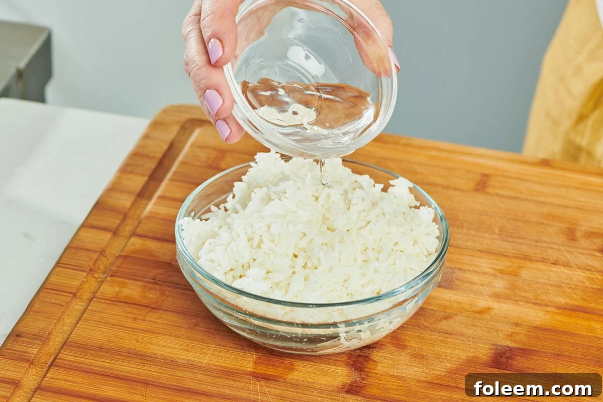 Adding water to glass bowl of leftover cooked rice.