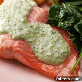 Poached Salmon topped with Cilantro Sauce on a plate.