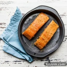 Thai Salmon on plate with blue napkin.
