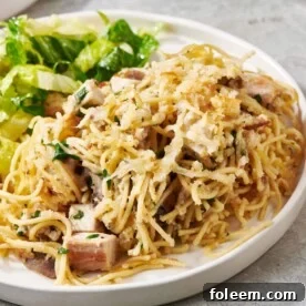 Turkey Tetrazzini and salad on a white plate.