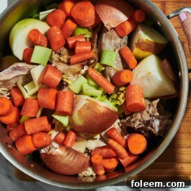 Turkey stock with carrots, onions, and bones in large stock pot.