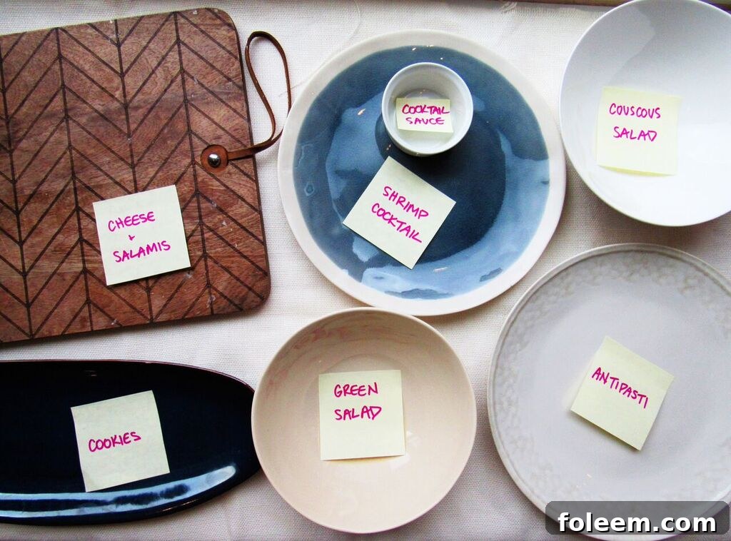 Plates with labels set on table for holiday open house buffet.
