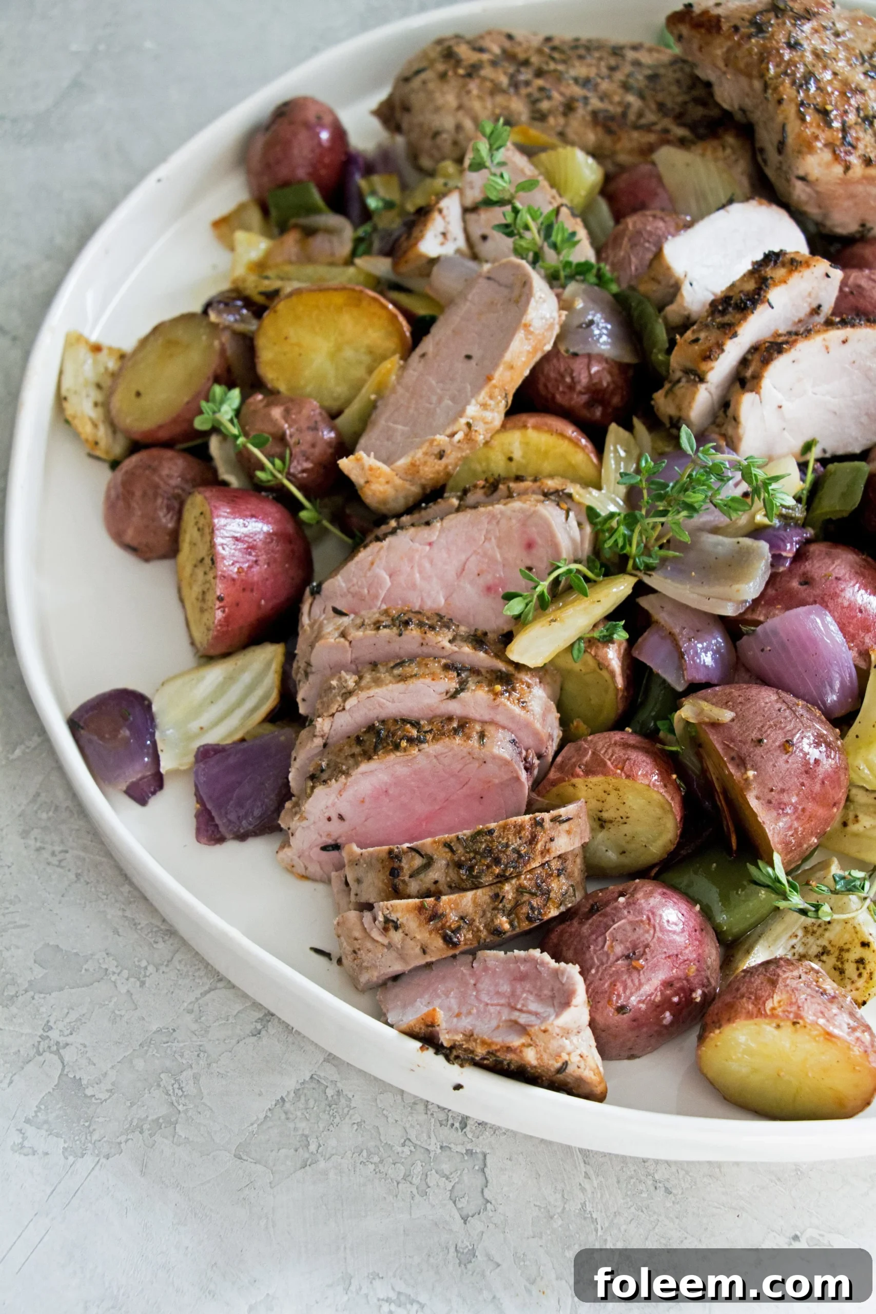Mediterranean Pork Tenderloin with Roasted Vegetables on a platter.