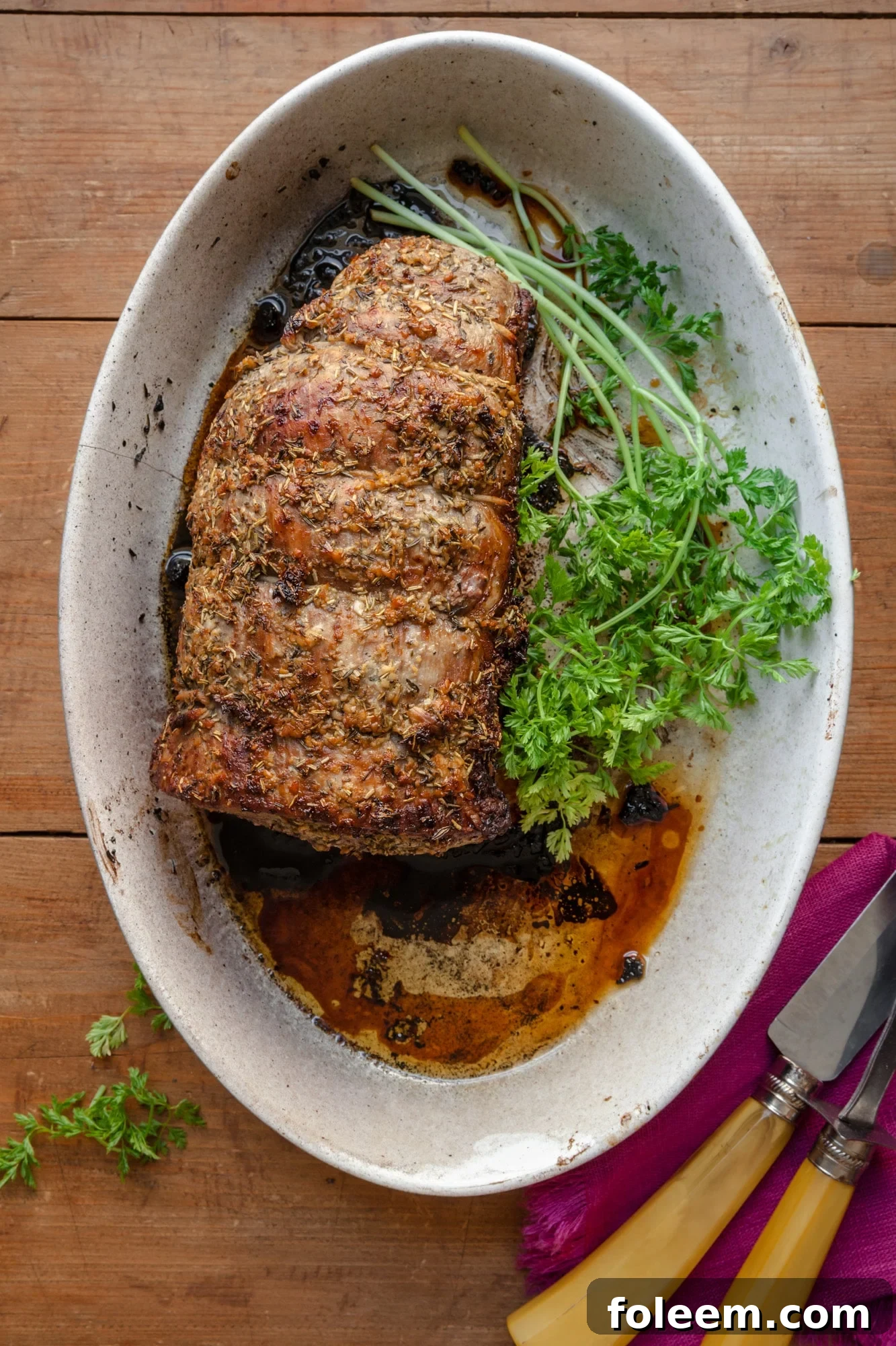 Roast Beef with Thyme and Rosemary in an oval white baking dish.