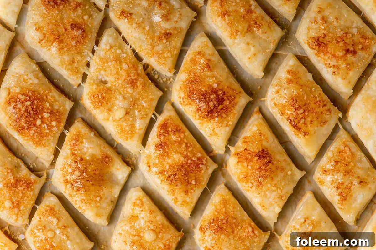 Baked puff pastry croutons on baking sheet.