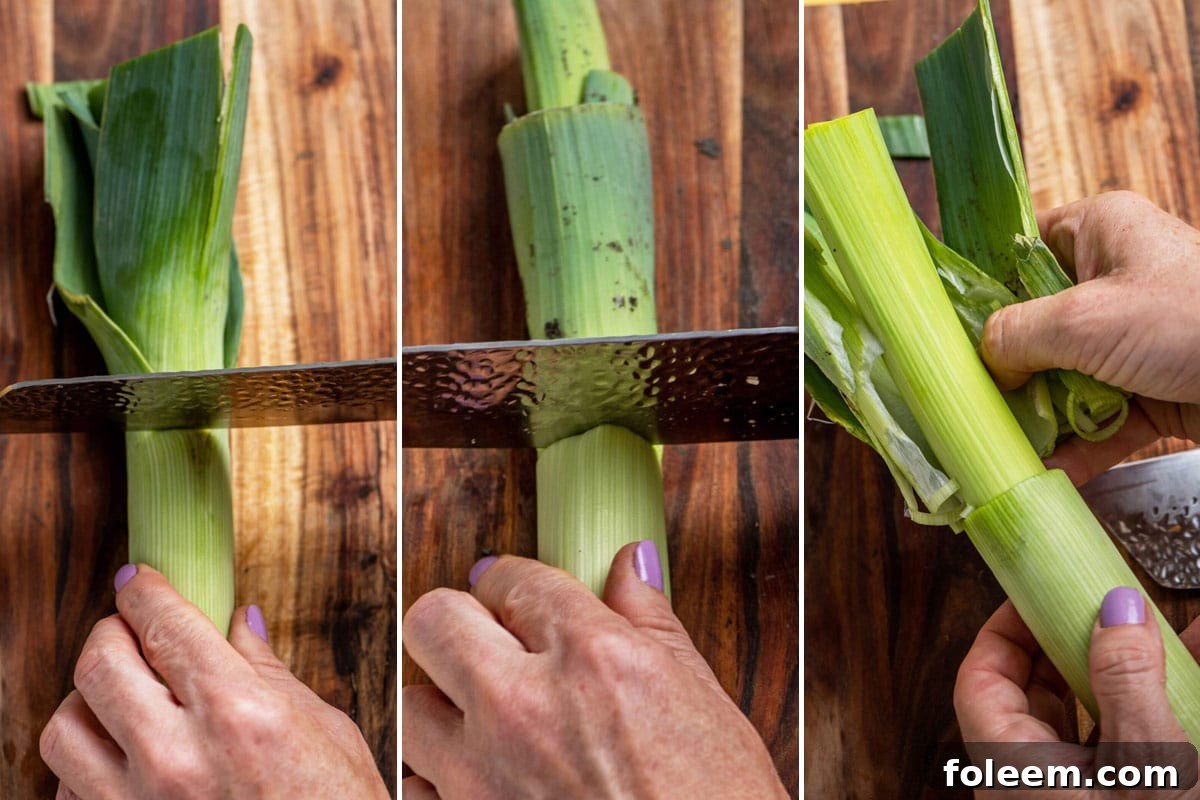 Trimming and removing the tough outer leaves from fresh leeks.