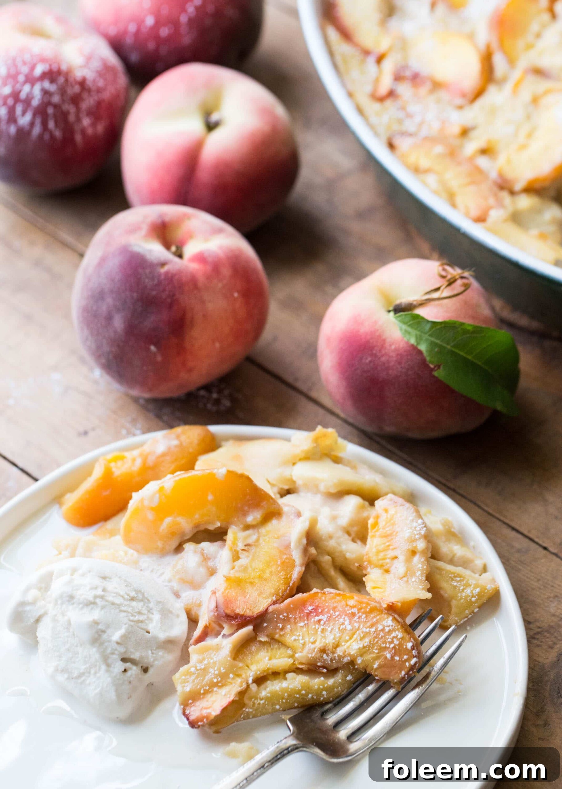 Plate with Peach Clafoutis and ice cream.