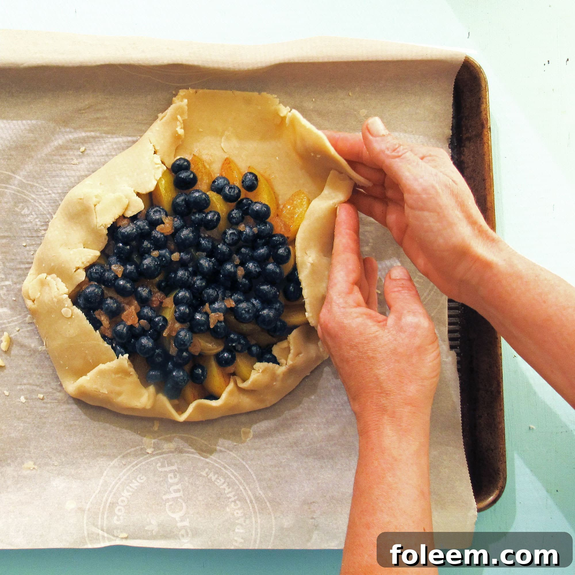 Folding over the pastry edges for a galette or crostada