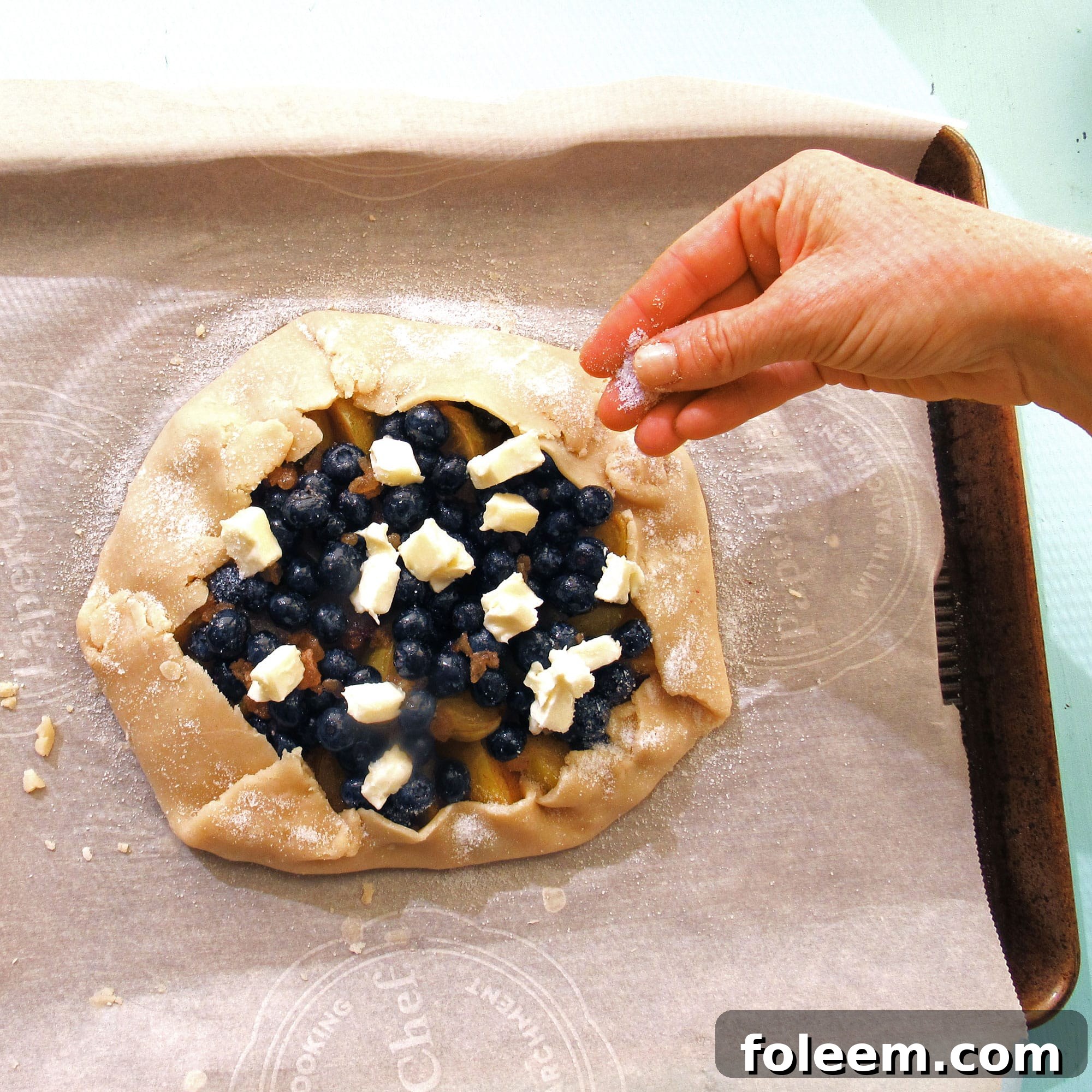 dotting a galette or crostata with butter before baking