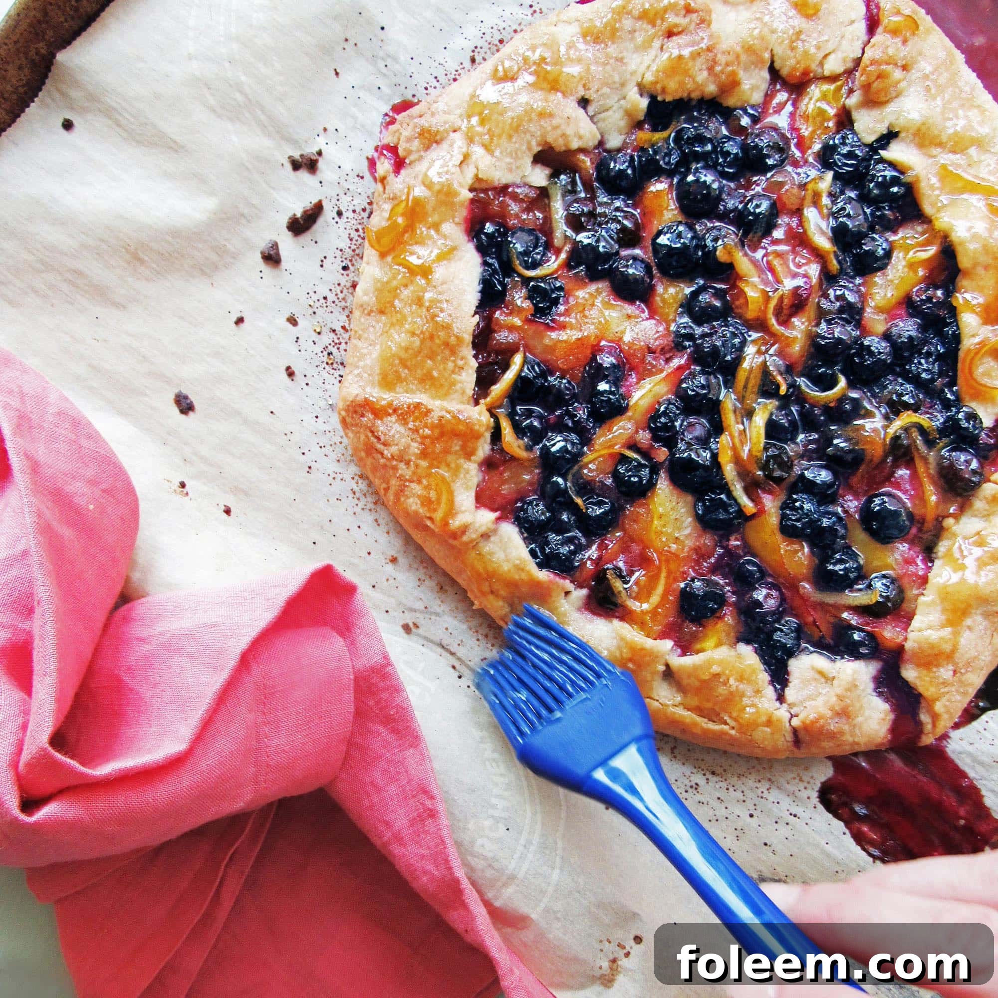 Brushing a baked galette with preserves