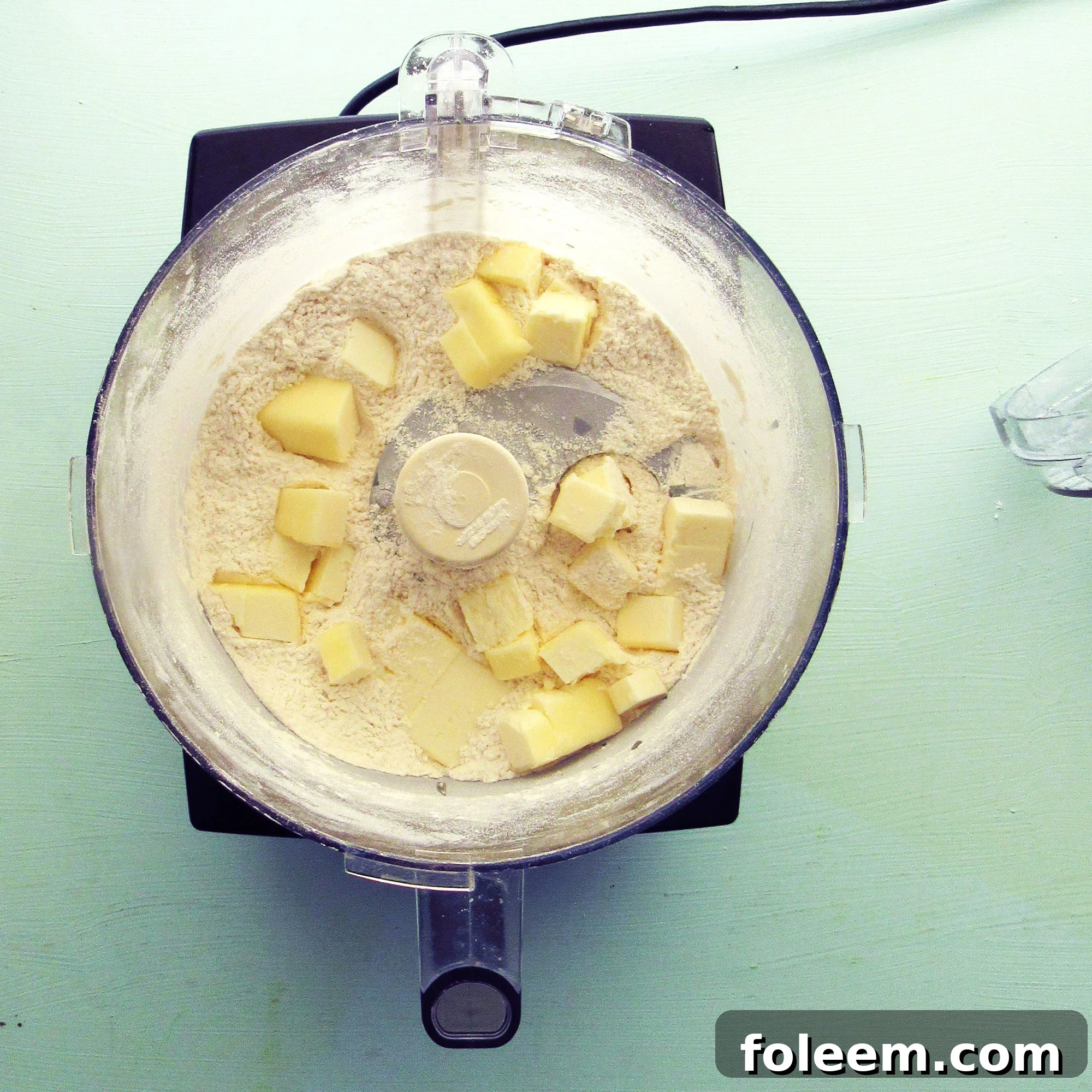 Cutting butter into dry ingredients in a food processor.