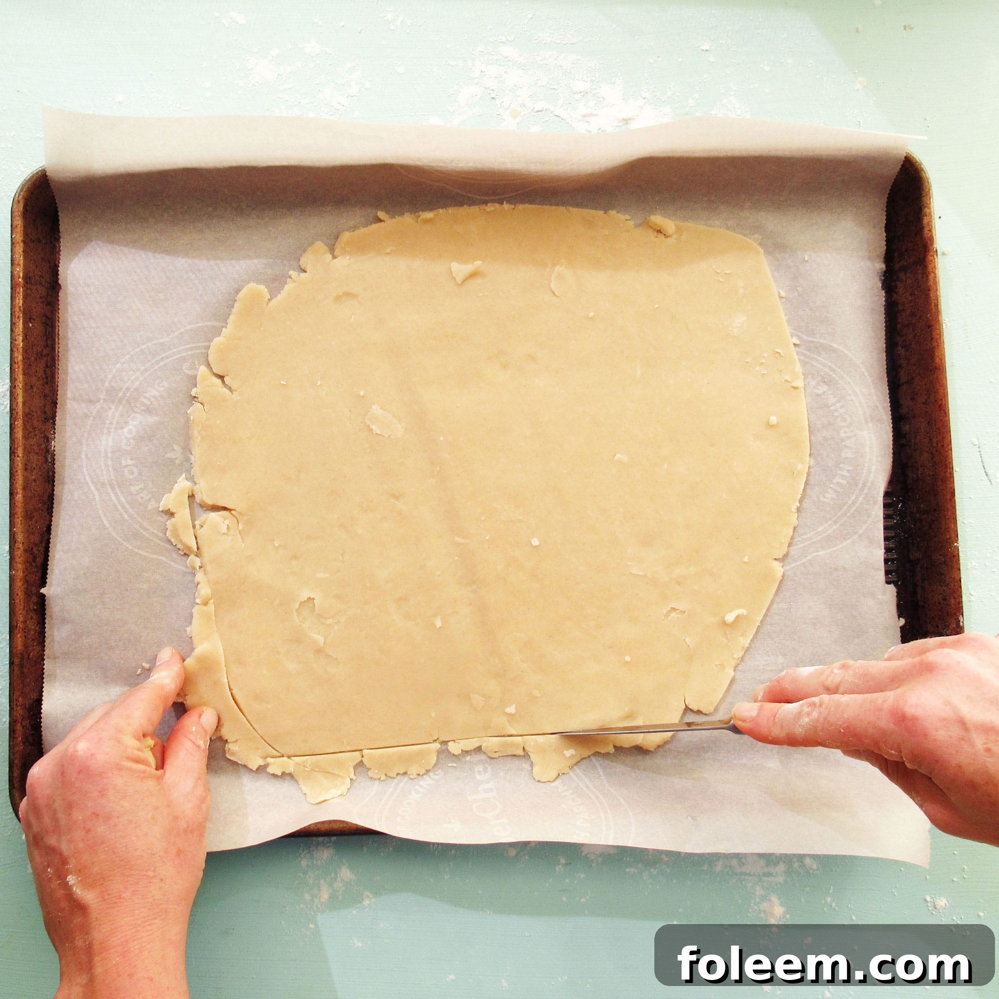 Trimming dough for a galette or crostata.
