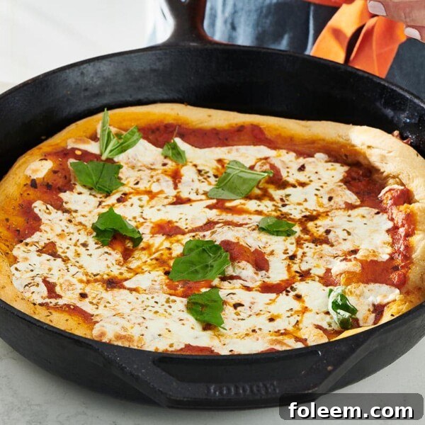 Cast Iron skillet with a Pizza.