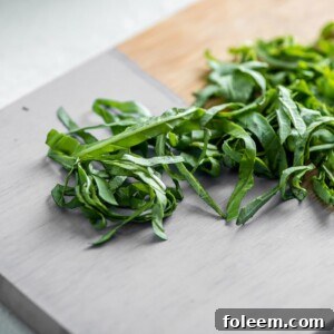 Chiffonaded fresh basil on cutting board.