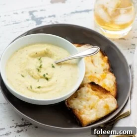 Plate with cheese toasts and a bowl of Parsnip and Golden Beet Soup.