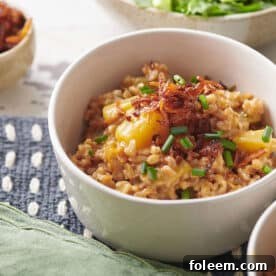 White bowls of Farrotto with Golden Beets, Mixed Herbs and Crispy Shallots.